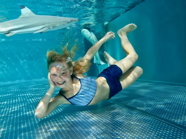 Little girl in shark tank — Stock Photo, Image