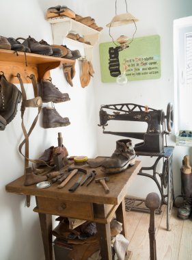 Historical workshop of a shoemaker clipart
