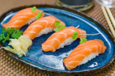 Lezzetli kaliteli somon nigiri mavi el yapımı tabak süslemeli