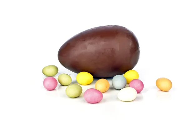 Chocolate egg with little colored eggs — Stock Photo, Image