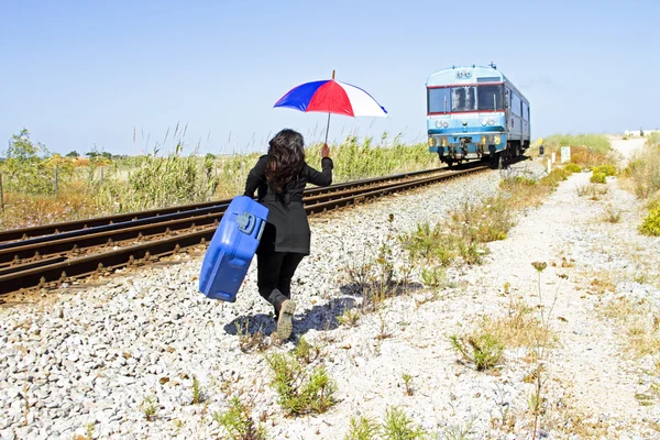 Young woman running after the train — Stock Photo, Image