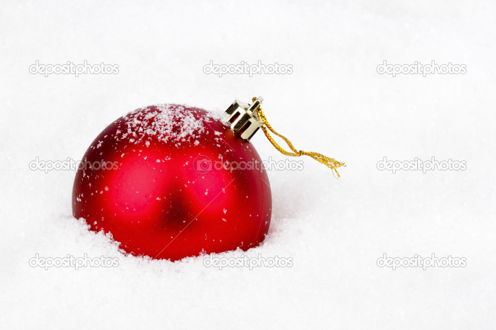 Red christmas ball in the snow