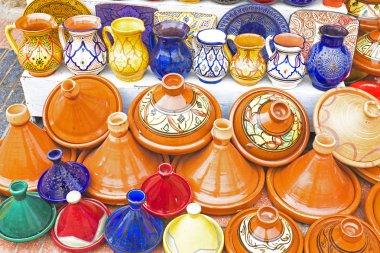 Colorful Tajines for sale in a market stall clipart
