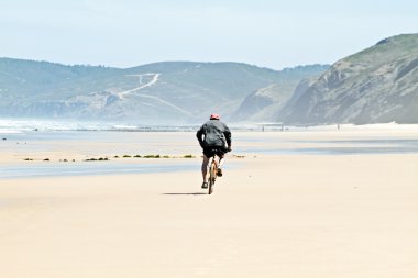Biker at the beach clipart