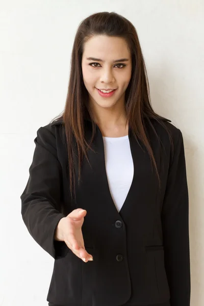 Female business executive offering greeting with hand shake — Stock Photo, Image
