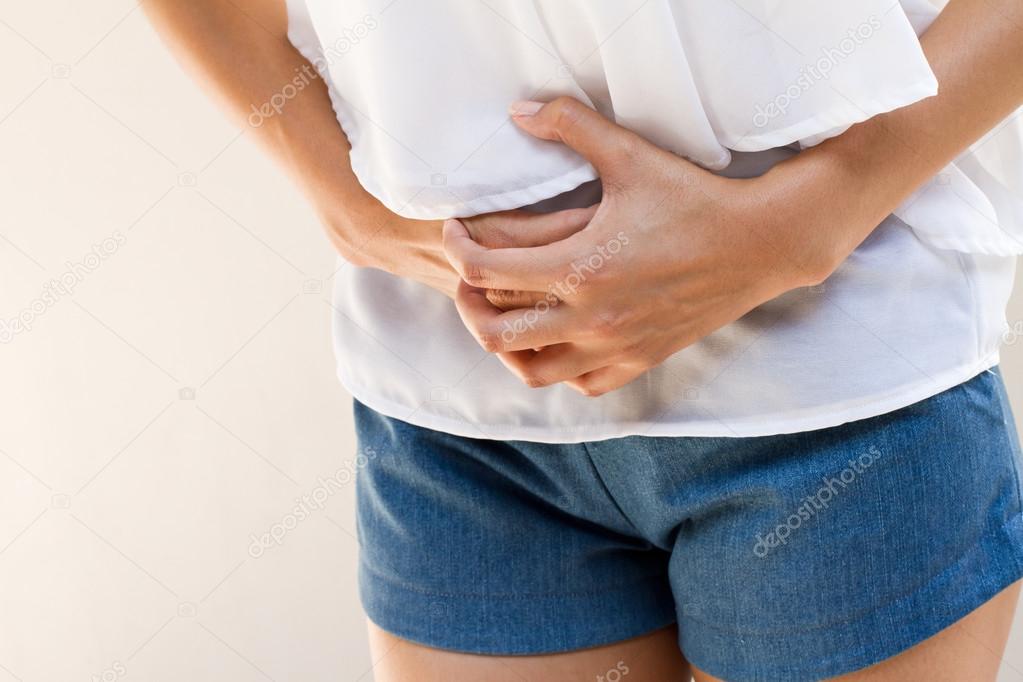 menstruation pain or stomach ache, hand holding belly closeup