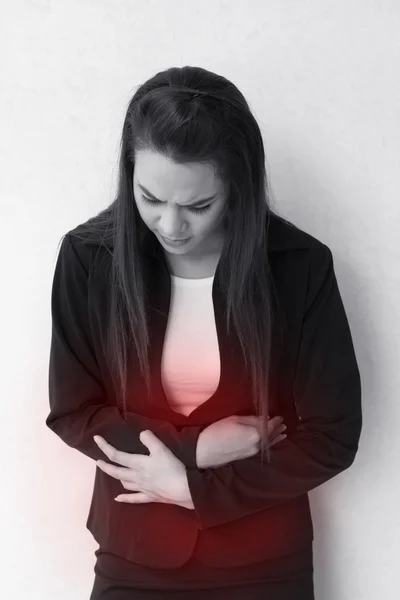 Menstruation pain or stomach trouble, with red danger accent — Stock Photo, Image