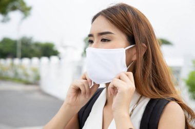 Woman office worker going to work with proper face mask wearing