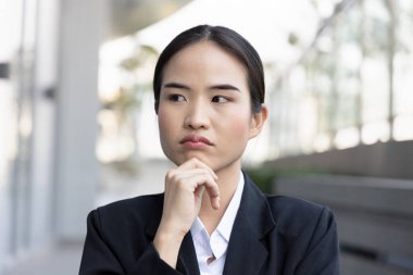 Stressed and unhappy asian woman office worker thinking