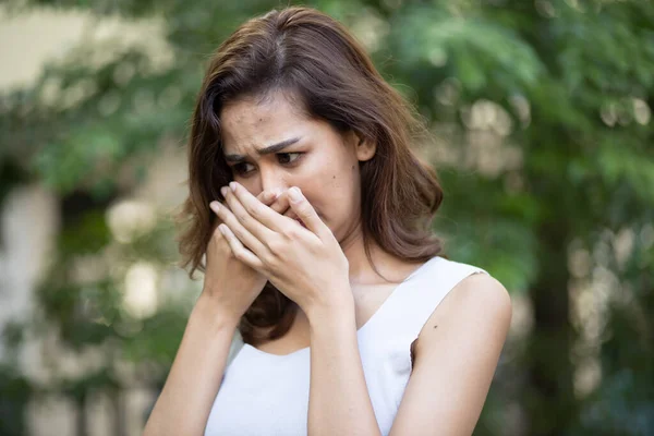 asian woman having bad breath problem