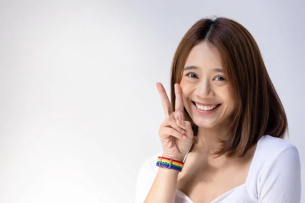 Happy Lgbt Woman Wearing Lgbtq Rainbow Wristband Showing Sign Victory — Stock Photo, Image