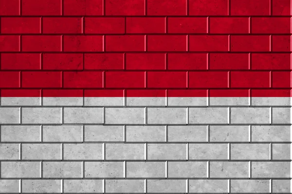 Bandeira de Mônaco pintada em uma parede de tijolo — Fotografia de Stock