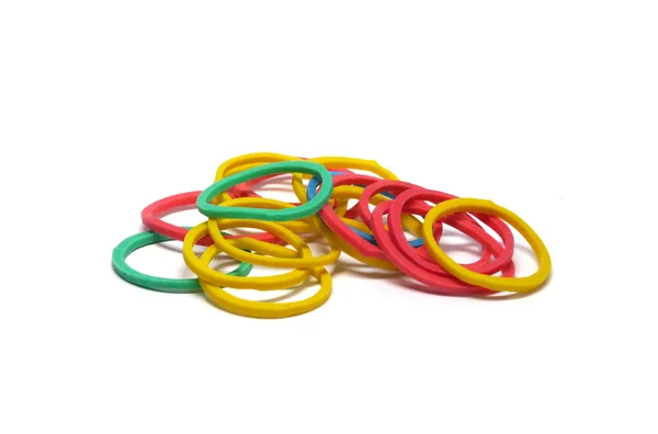 Brightly coloured elastic rubber bands over white — Stock Photo, Image