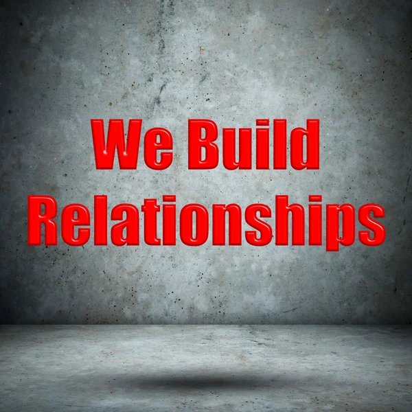Vi bygger relationer betonmur - Stock-foto