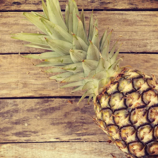 Pineapple on wood old retro vintage style — Stock Photo, Image