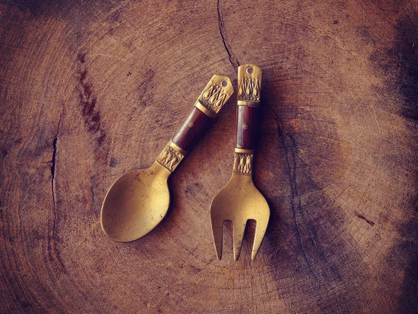 Golden spoon on wood background old retro vintage style — Stock Photo, Image