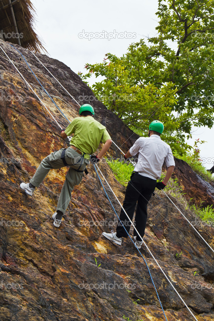 Father and son do cliff abseiling recreation in Thailand