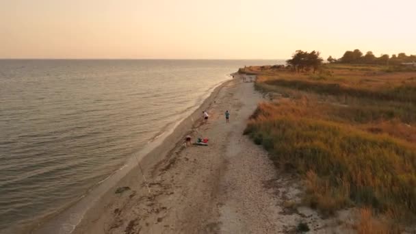 Vista aérea superior de 4k sobre el mar de playa de arena puesta del sol. Grecia pueblo costero pequeñas casas bahía mar tracio — Vídeos de Stock