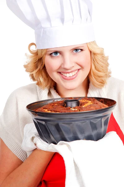 Mujer con pastel de paquete con un delantal rojo —  Fotos de Stock