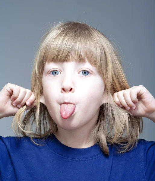 Boy sticking out tongue — Stock Photo, Image