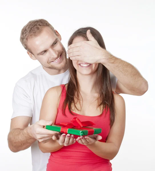 Young man giving a surprise present to his girlfriend — Stock Photo, Image