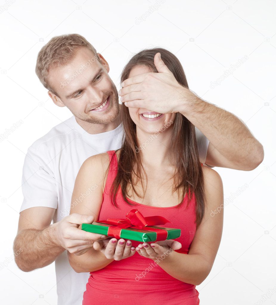 young man giving a surprise present to his girlfriend