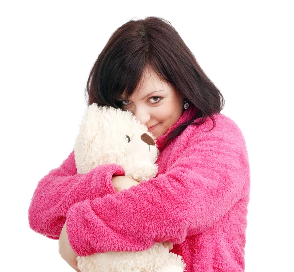 Jovem mulher de roupão rosa abraçando seu ursinho de pelúcia — Fotografia de Stock
