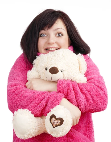 Jovem mulher de roupão rosa abraçando seu ursinho de pelúcia — Fotografia de Stock
