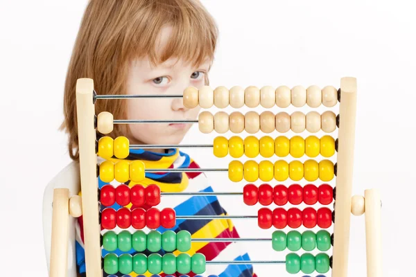 Menino olhando para colorido Abacus de madeira Pensando — Fotografia de Stock
