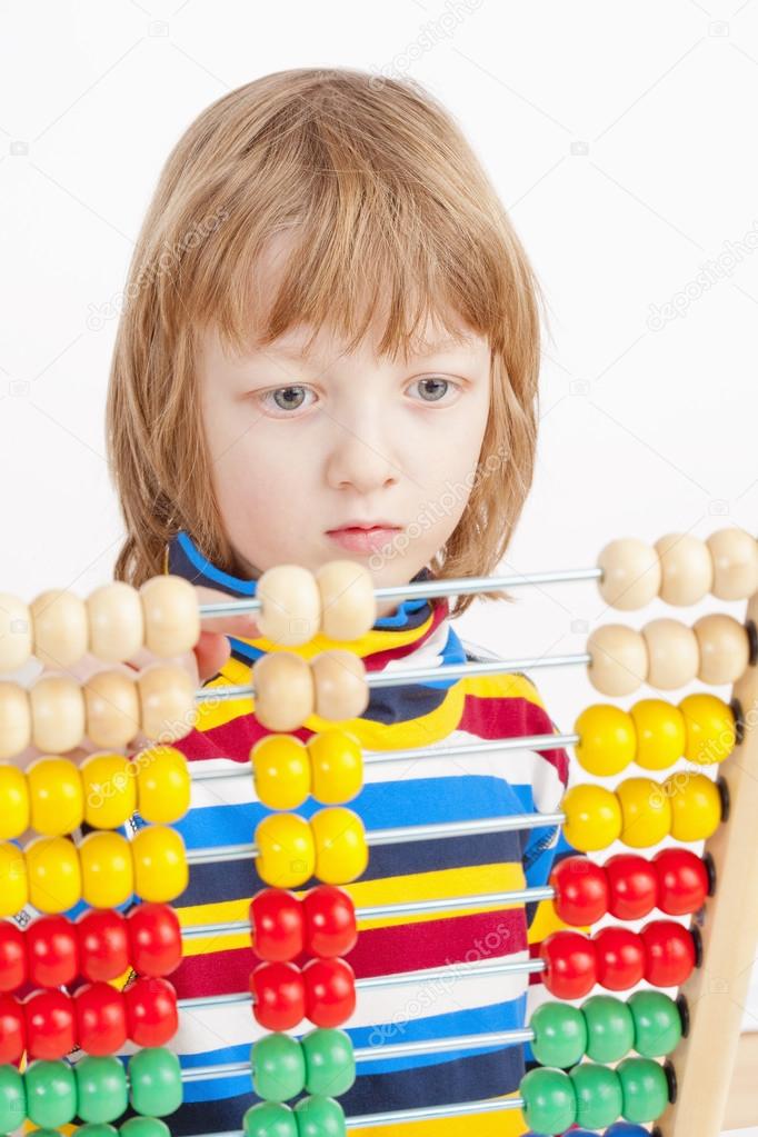 Child Counting on Colorful Wooden Abacus