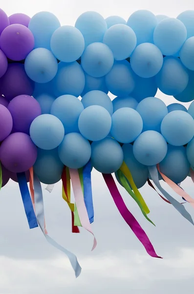 Balloons with developing colorful ribbons — Stock Photo, Image