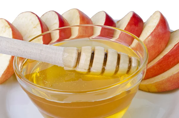 Tagliare a fette di mele con una ciotola di miele primo piano — Foto Stock