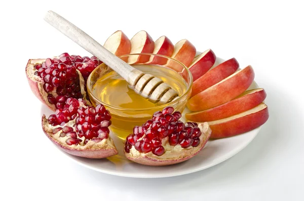 Cut into slices of apples, pomegranate and bowl of honey — Stock Photo, Image