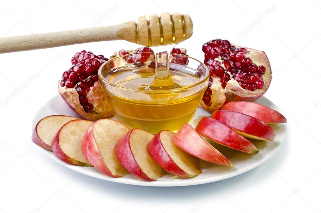 Cut into slices of apples, pomegranate and bowl of honey
