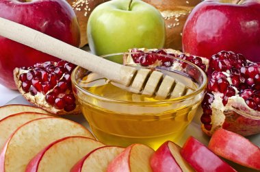 Still life closeup - challah, apples, pomegranate and bowl of ho