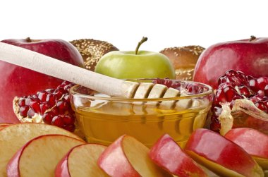 Still life closeup - challah, apples, pomegranate and bowl of ho