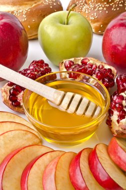 Still life closeup - challah, apples, pomegranate and bowl of ho