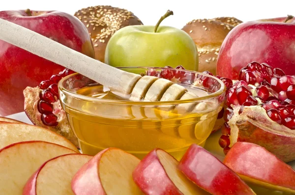 Still life closeup - challah, apples, pomegranate and bowl of ho