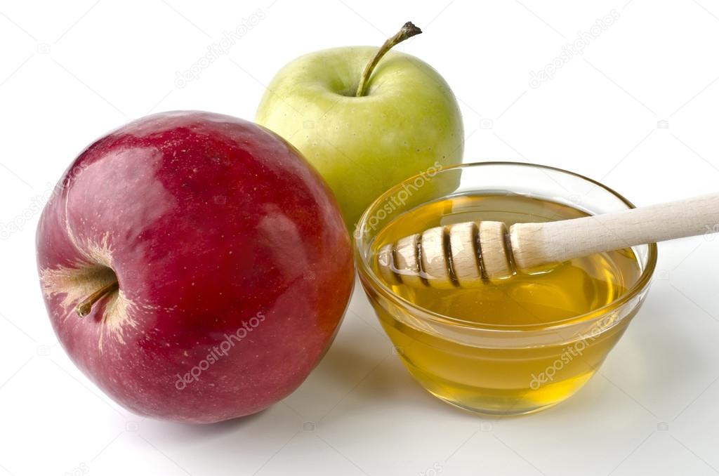 Red and green apples and a bowl of honey