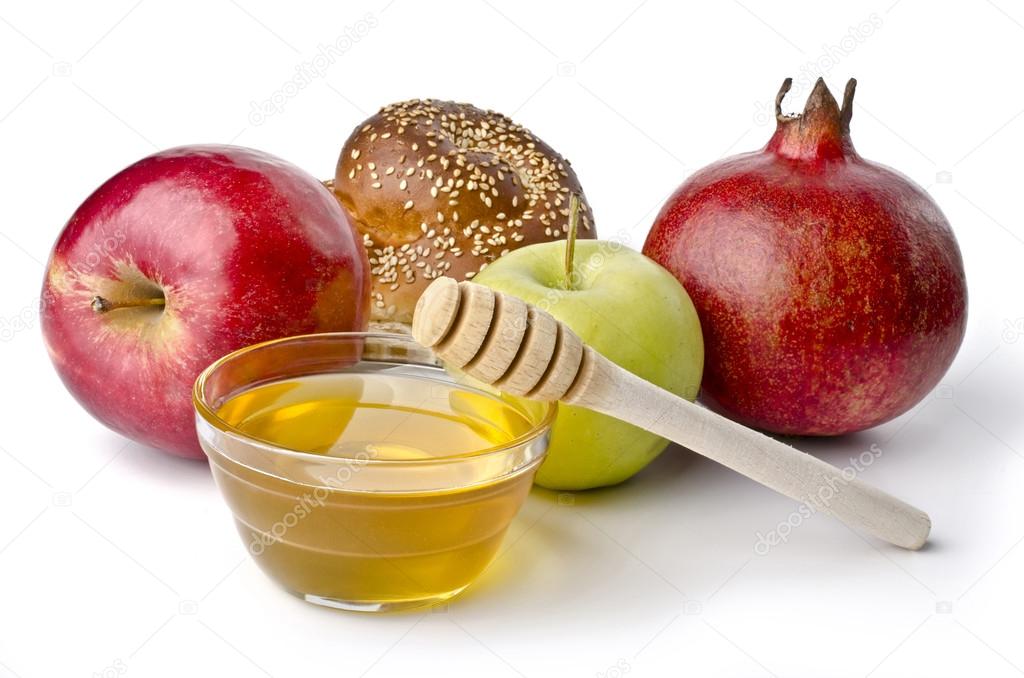 Round challah, apples and a bowl of honey