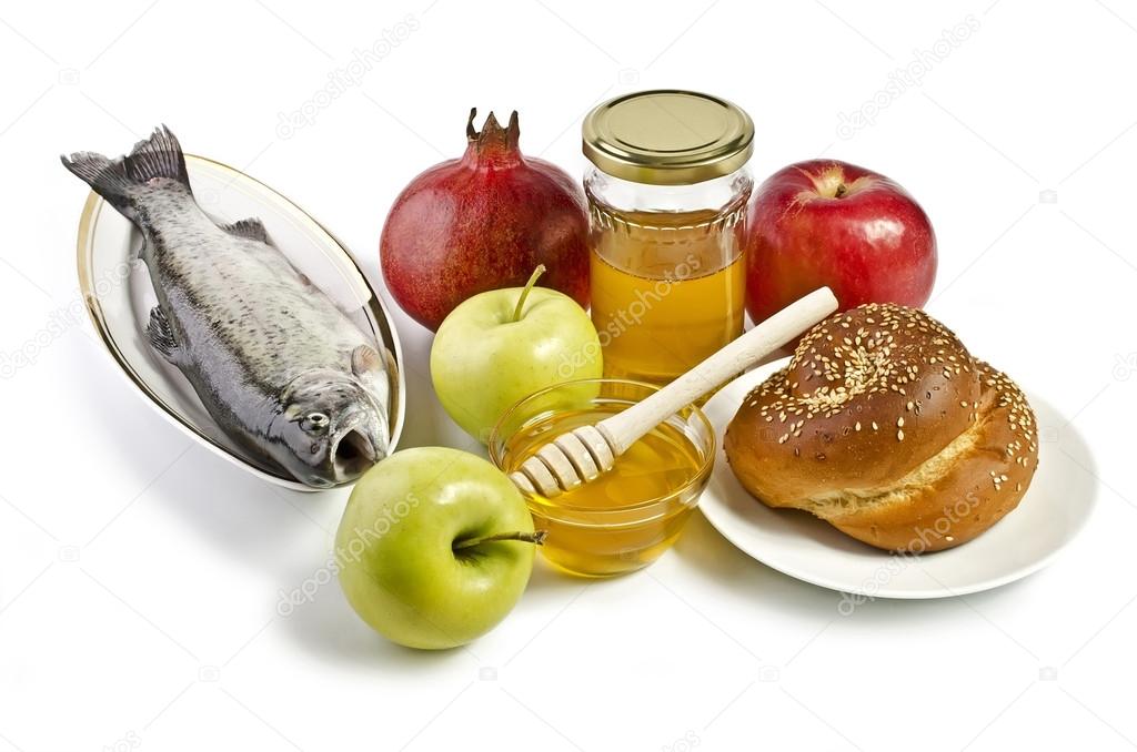 Still life with apples, pomegranates, fish, challah and honey