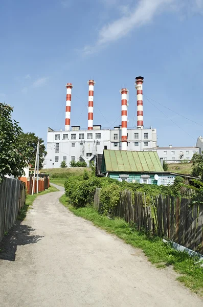 Industrial building on a background of the village — Stock Photo, Image