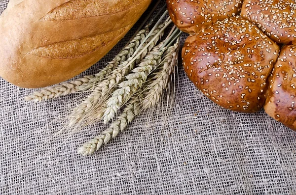 Pane e spighe di grano sdraiato sul sacco — Foto Stock