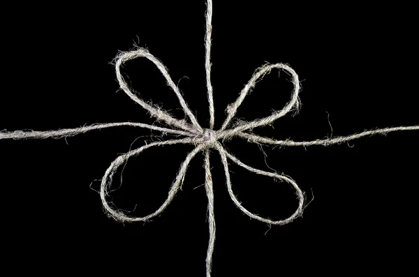 Bow made of twine isolated over black — Stock Photo, Image