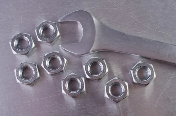 Metal nuts and wrench — Stock Photo, Image