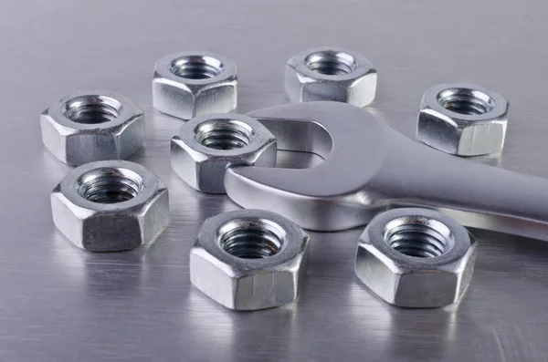 Metal nuts and wrench — Stock Photo, Image
