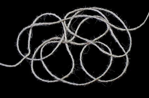 Tangled ball of twine isolated over black — Stock Photo, Image