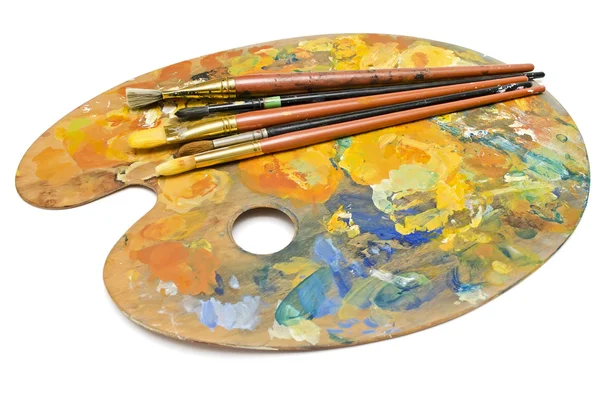 Paint brushes on a palette — Stock Photo, Image