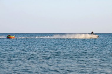 Attraction on the beach in the Crimea - jet ski carries tourists