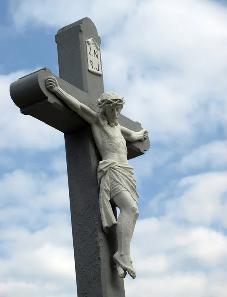 Cross on a blue and cloudy sky — Stock Photo, Image